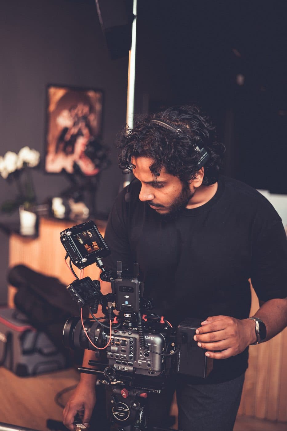 Hyped Visuals camera operator filming an interview setup on a corporate production set