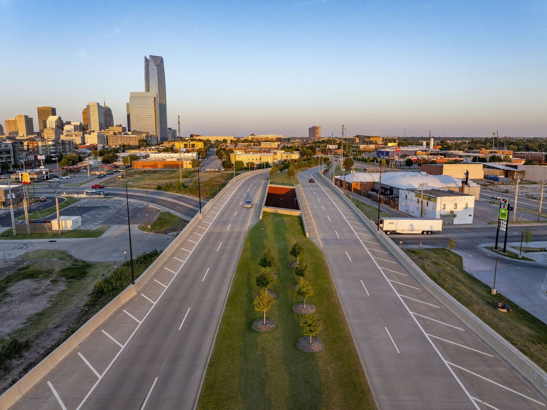 A divided boulevard leading toward the downtown Oklahoma City skyline and Devon Tower